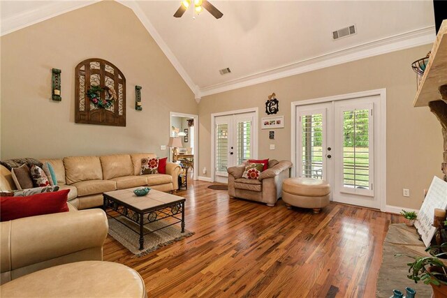 living room with high vaulted ceiling, wood-type flooring, crown molding, ceiling fan, and french doors