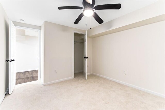 unfurnished bedroom with light colored carpet and ceiling fan