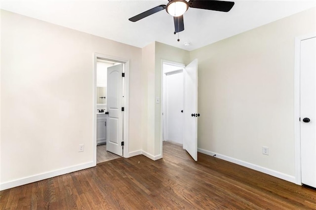 unfurnished bedroom with ensuite bath, ceiling fan, and dark hardwood / wood-style flooring