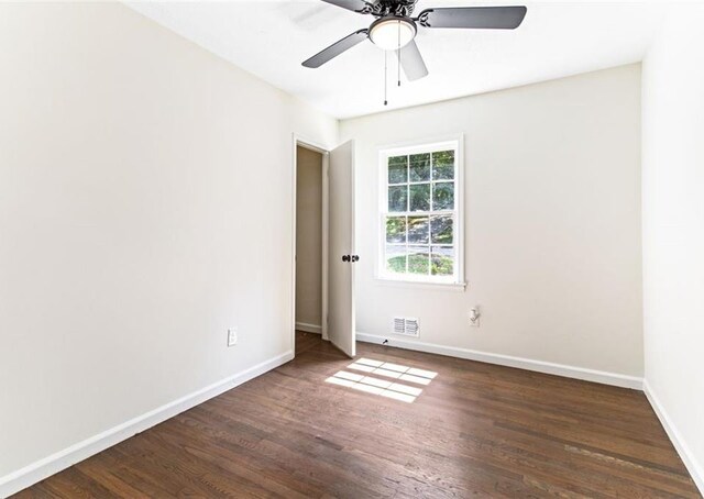 empty room featuring ceiling fan and dark hardwood / wood-style floors