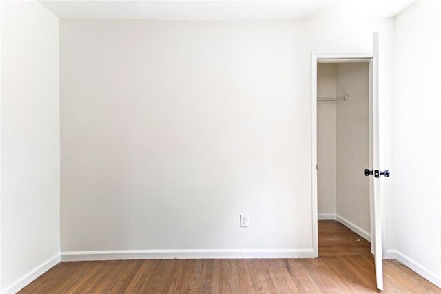 unfurnished bedroom featuring hardwood / wood-style flooring and a closet