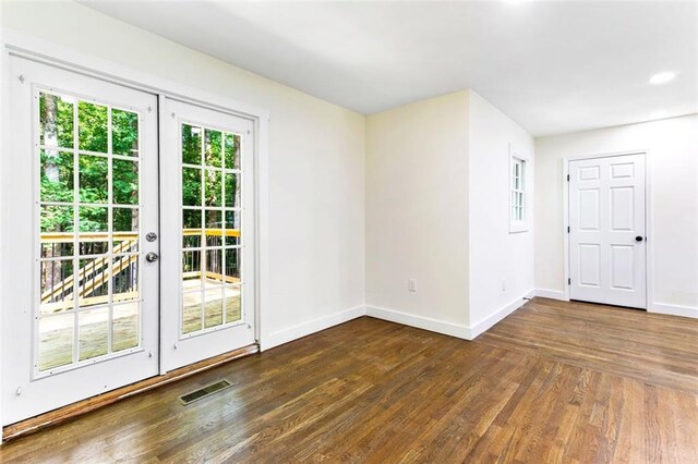 unfurnished room with french doors and dark hardwood / wood-style floors