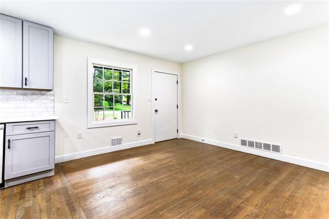 unfurnished dining area featuring dark hardwood / wood-style floors