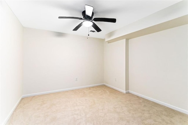 carpeted empty room featuring ceiling fan