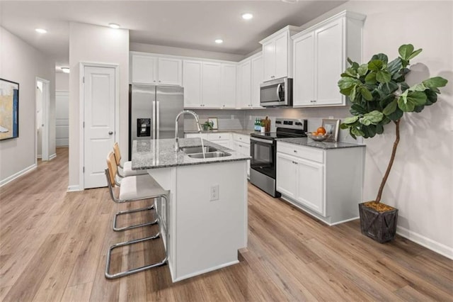 1346 Riverstone Rd Unit 107, Jonesboro, GA 30238 - kitchen featuring a sink, baseboards, appliances with stainless steel finishes, and white cabinets