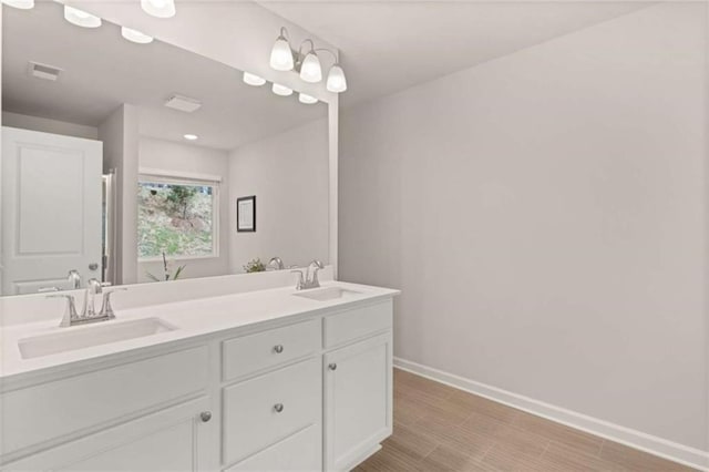 1346 Riverstone Rd Unit 107, Jonesboro, GA 30238 - bathroom with baseboards, double vanity, a sink, and visible vents