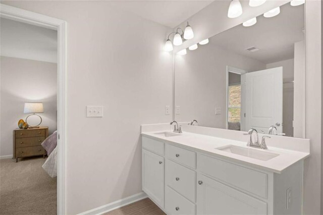 1346 Riverstone Rd Unit 107, Jonesboro, GA 30238 - bathroom featuring double vanity, ensuite bathroom, baseboards, and a sink