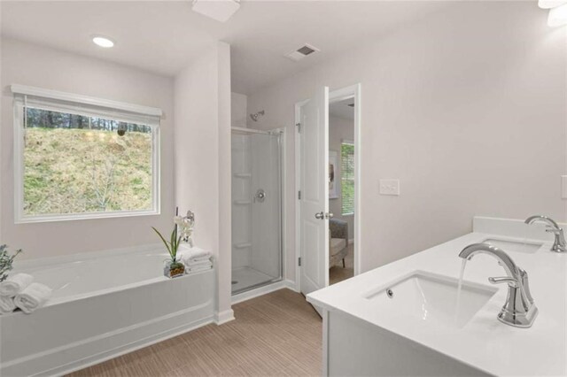 1346 Riverstone Rd Unit 107, Jonesboro, GA 30238 - bathroom featuring double vanity, a garden tub, a sink, and a stall shower