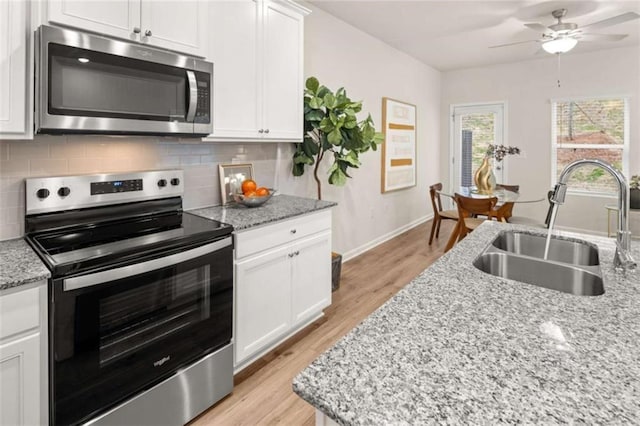 1346 Riverstone Rd Unit 107, Jonesboro, GA 30238 - kitchen with stainless steel appliances, a ceiling fan, a sink, and backsplash