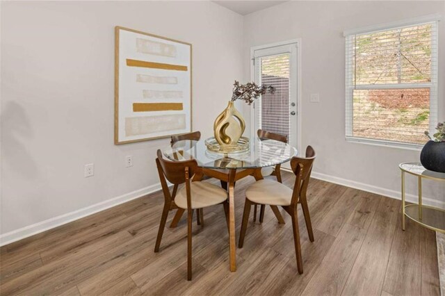 1346 Riverstone Rd Unit 107, Jonesboro, GA 30238 - dining area with wood finished floors and baseboards