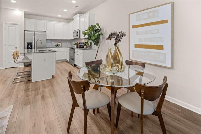 1346 Riverstone Rd Unit 107, Jonesboro, GA 30238 - dining space featuring baseboards, light wood finished floors, and recessed lighting
