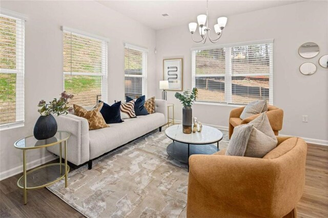 1346 Riverstone Rd Unit 107, Jonesboro, GA 30238 - living area featuring wood finished floors, an inviting chandelier, and baseboards