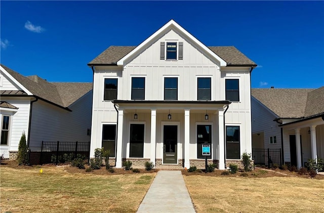 modern inspired farmhouse featuring a porch and a front lawn