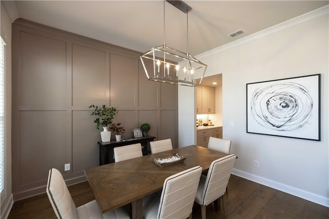 dining room featuring crown molding and dark wood-type flooring