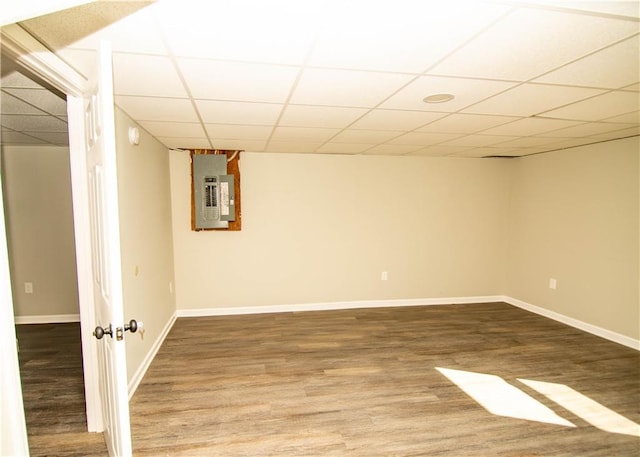 basement with hardwood / wood-style flooring, a paneled ceiling, and electric panel