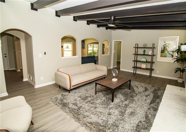 living room with beam ceiling, ceiling fan, and hardwood / wood-style flooring