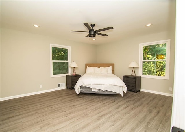 bedroom with ceiling fan and hardwood / wood-style floors