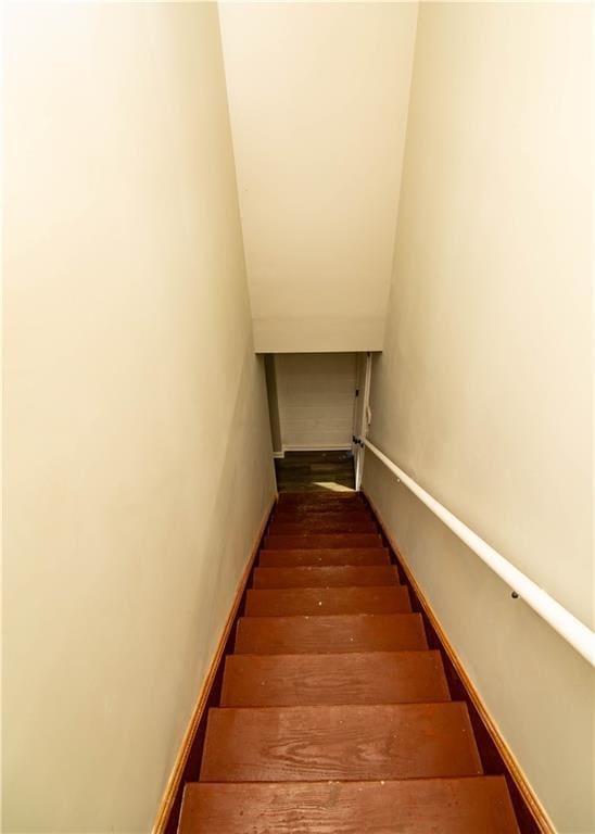 stairway featuring wood-type flooring