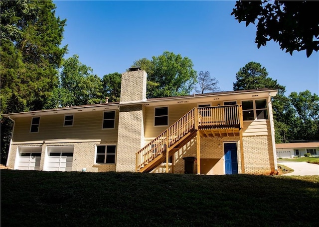 back of house featuring a wooden deck and a garage