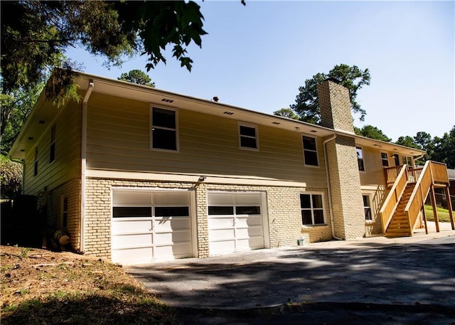 exterior space with a garage and a deck