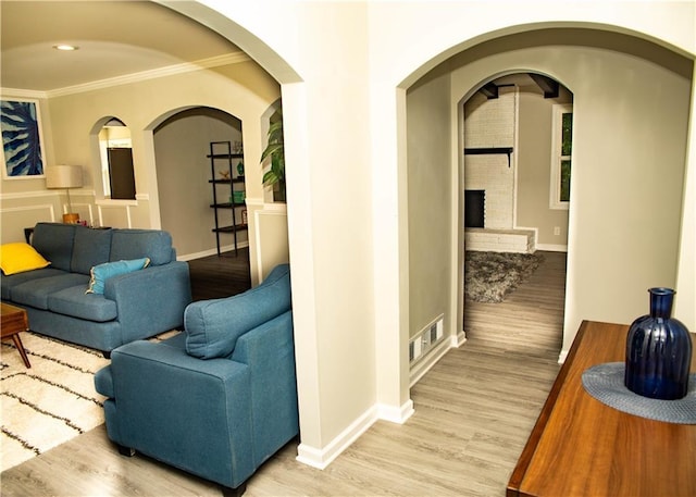 hall with crown molding and light wood-type flooring