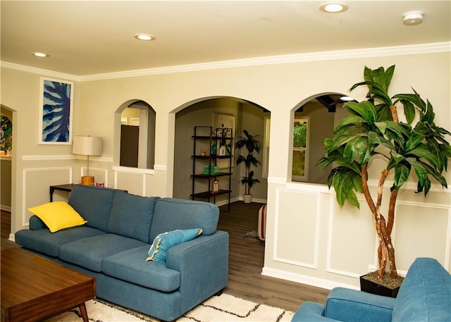 living room featuring wood-type flooring and crown molding