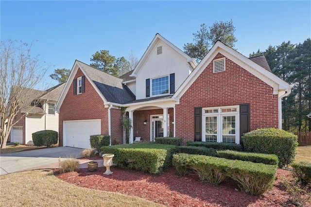 traditional-style house featuring brick siding, concrete driveway, and an attached garage