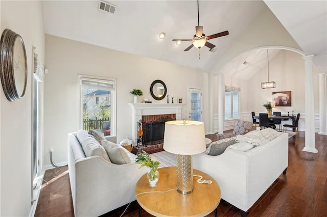 living area with lofted ceiling, decorative columns, visible vents, and a wealth of natural light