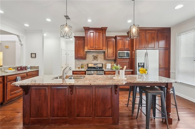 kitchen with stainless steel appliances, crown molding, and a sink