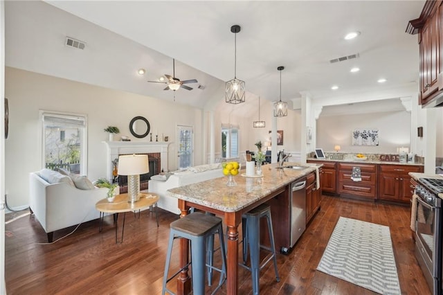 kitchen with a wealth of natural light, open floor plan, visible vents, and appliances with stainless steel finishes