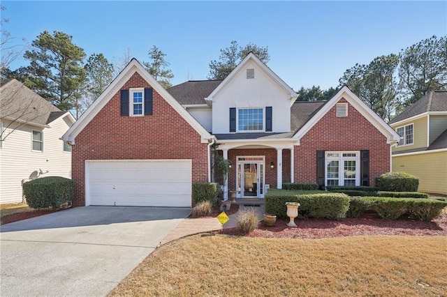 traditional-style home with a front lawn, an attached garage, brick siding, and driveway