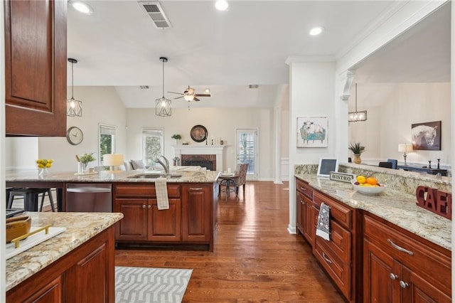 kitchen featuring a sink, ceiling fan, open floor plan, a fireplace, and stainless steel dishwasher