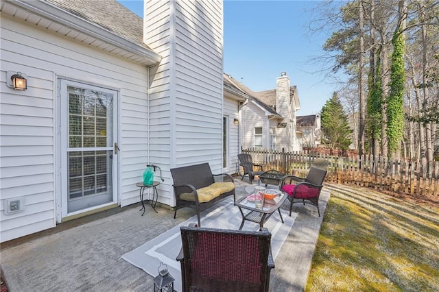 view of patio / terrace with fence and an outdoor hangout area