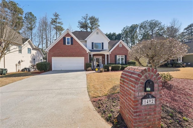 traditional-style home featuring brick siding, driveway, and a front yard