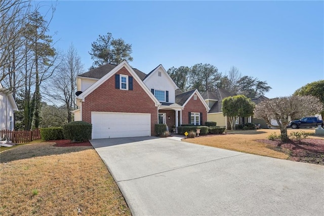 traditional home featuring driveway, brick siding, a front yard, and fence