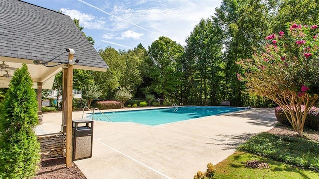 outdoor pool with a patio area