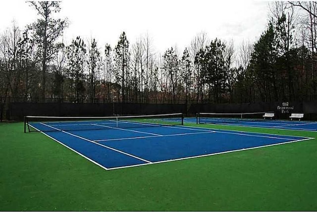 view of tennis court featuring fence