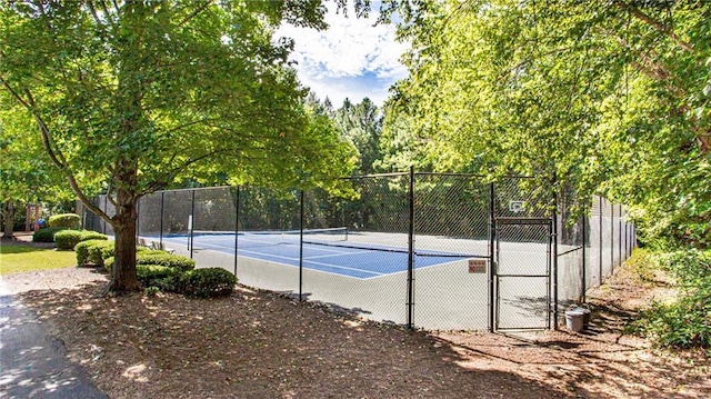 view of sport court with fence and a gate