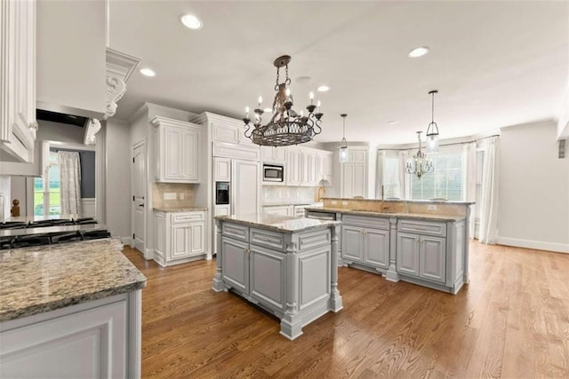 2539 Sagebrush Trl, Buford, GA 30519 - kitchen featuring stainless steel appliances, gray cabinetry, a chandelier, a center island, and recessed lighting