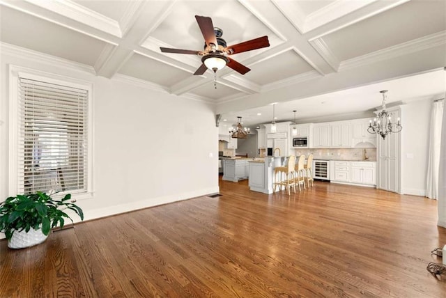 2539 Sagebrush Trl, Buford, GA 30519 - unfurnished living room featuring beverage cooler, a chandelier, coffered ceiling, ceiling fan, and beamed ceiling
