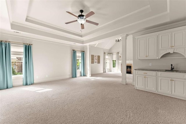 2539 Sagebrush Trl, Buford, GA 30519 - unfurnished living room featuring a tray ceiling, light colored carpet, ceiling fan, and ornamental molding