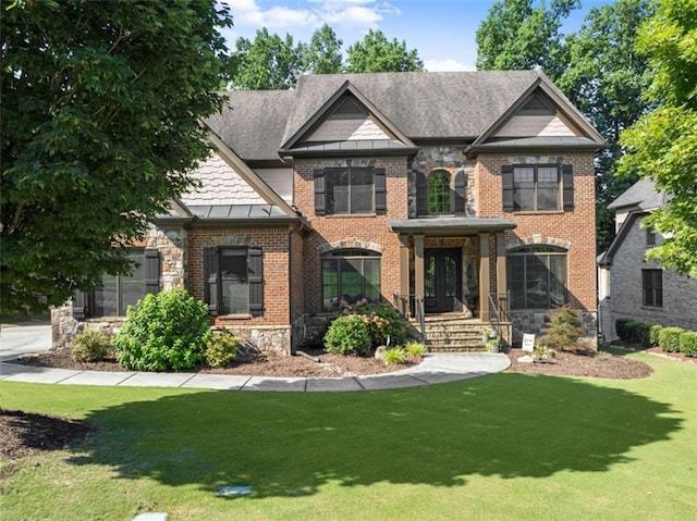 2539 Sagebrush Trl, Buford, GA 30519 - french country home with a front yard, stone siding, brick siding, and a standing seam roof