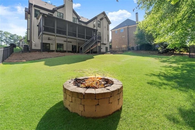 2539 Sagebrush Trl, Buford, GA 30519 - fenced backyard featuring an outdoor fire pit, stairs, and a sunroom
