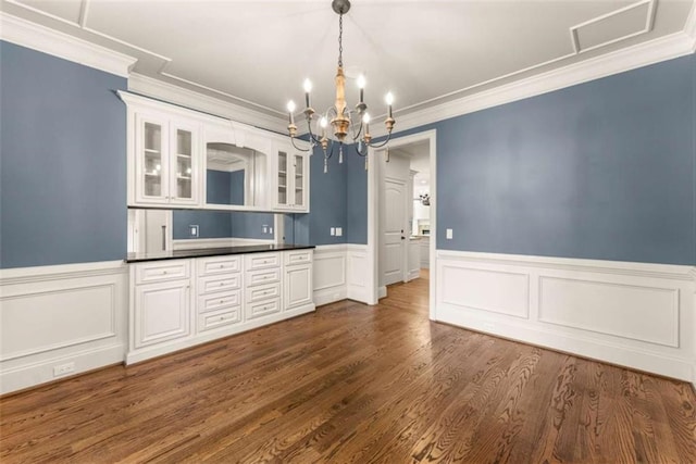 2539 Sagebrush Trl, Buford, GA 30519 - kitchen with a chandelier, crown molding, glass insert cabinets, wainscoting, and dark countertops