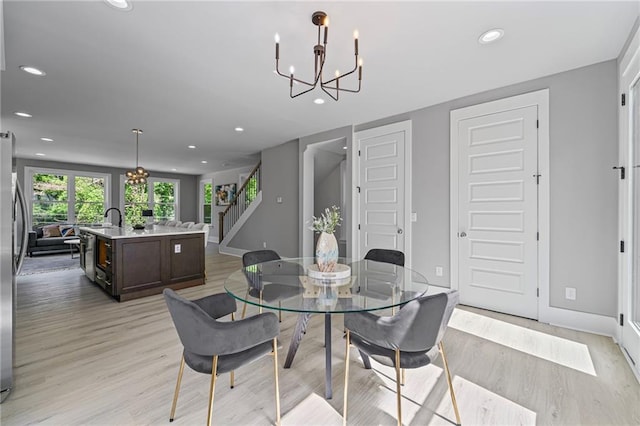 101 Fairfield Ct, Atlanta, GA 30314 - dining area with a chandelier, light wood-style floors, recessed lighting, stairway, and baseboards