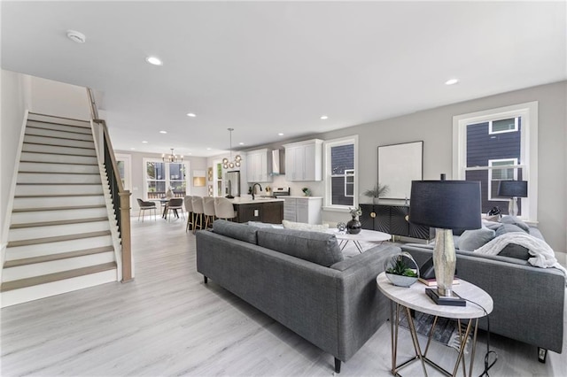101 Fairfield Ct, Atlanta, GA 30314 - living area with stairs, light wood finished floors, recessed lighting, and a chandelier
