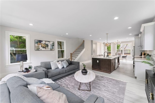 101 Fairfield Ct, Atlanta, GA 30314 - living area with light wood finished floors, recessed lighting, baseboards, a chandelier, and stairs