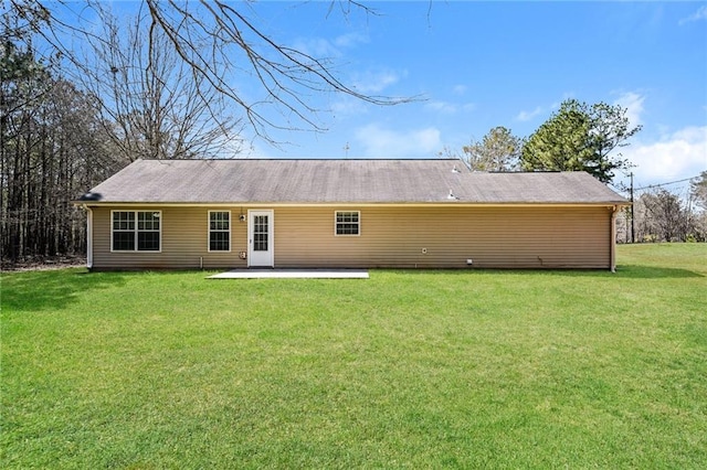 rear view of house with a patio area and a yard