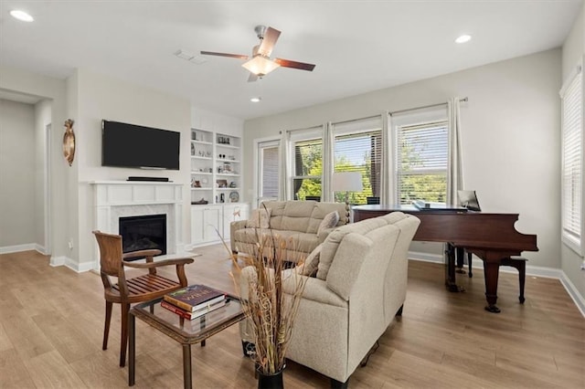 living room with ceiling fan and light hardwood / wood-style flooring