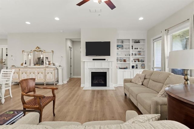 living room featuring ceiling fan and light hardwood / wood-style flooring